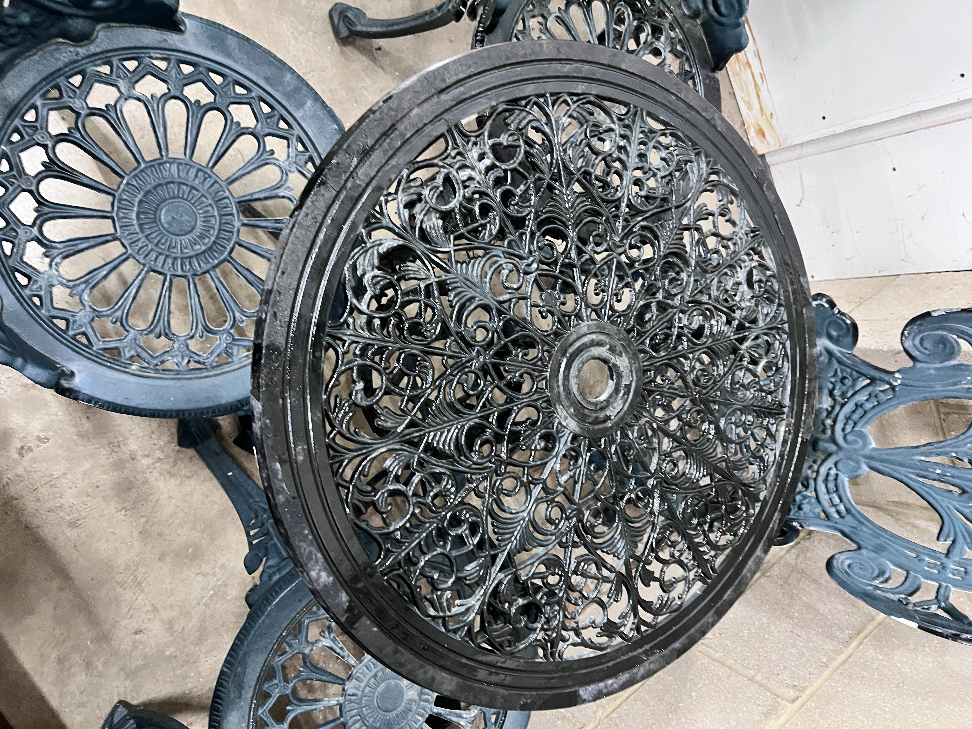 A Victorian style aluminium circular garden table, diameter 60cm, height 62cm and four chairs
